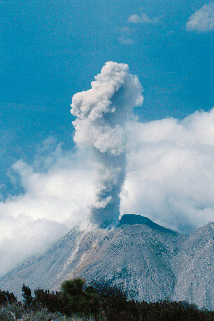 Volcan Santiaguito erupting as seen from the summit of nearby Volcan Santa María, above Quetzaltenango (Xela), Guatemala.