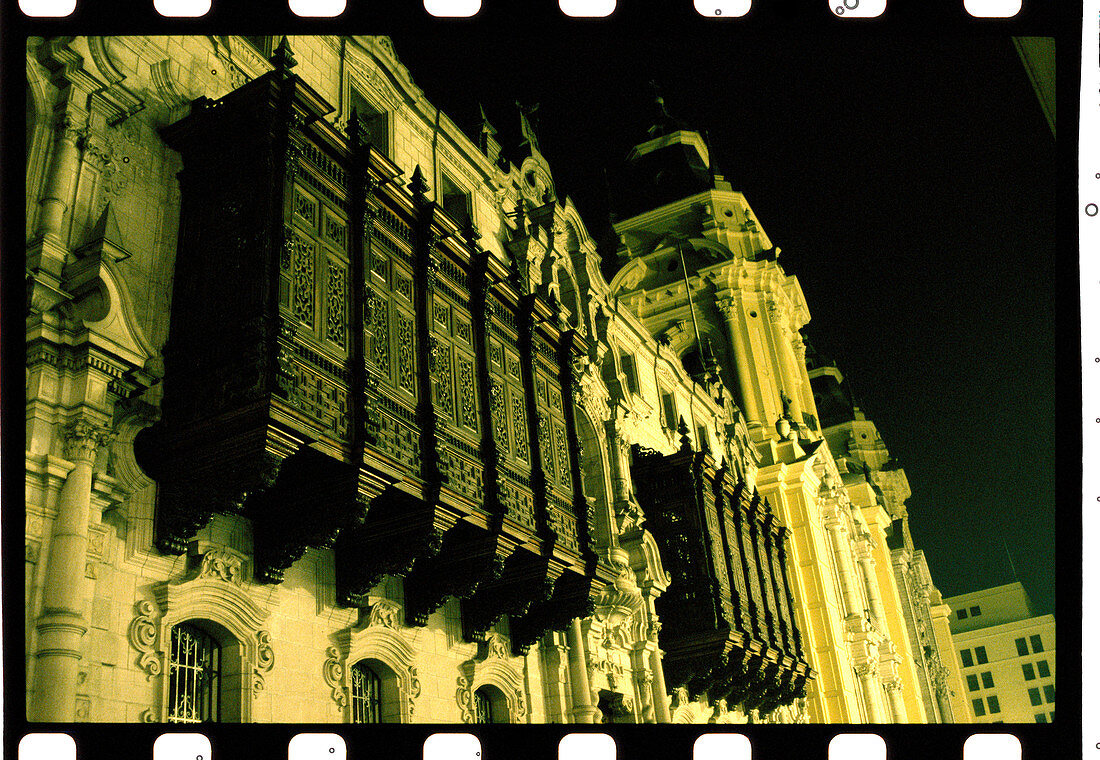 Elaborate facade of the Palacio del Arzobispado (Archiepiscopate palace) at night. Plaza de Armas. Lima. Peru