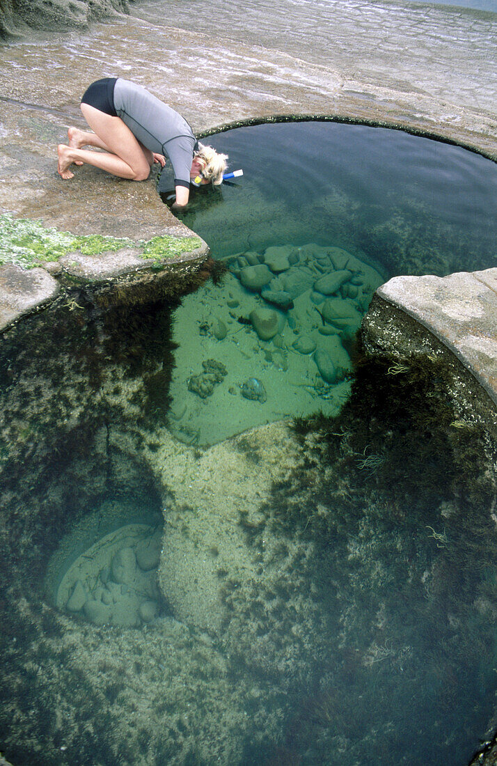 Young woman with mask and snorkel at Figure Eight Pools, Royal National Park, near Sydney, New South Wales, Australia