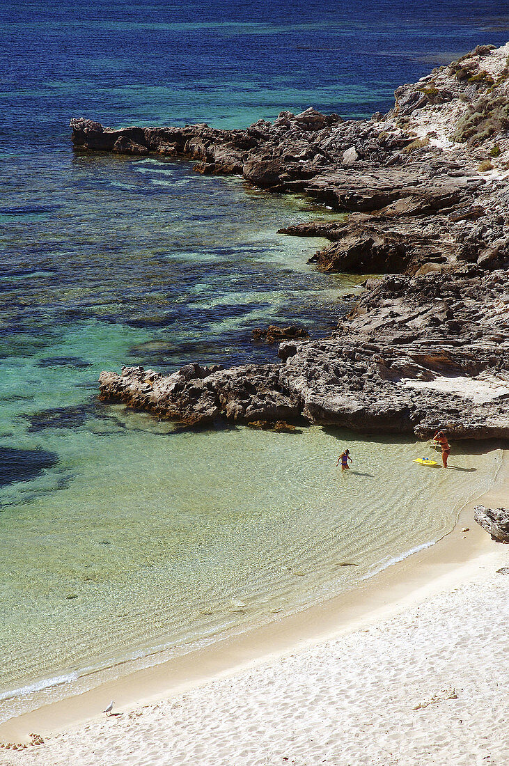 Mother and daughter about to set off for a snorkel in Little Armstrong Bay, Rottnest Island, Western Australia.