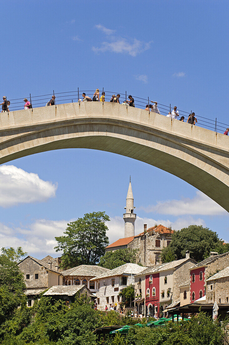 Tourists on the new Old Bridge over the river Neretva Mostar Bosnia and Herzogovina