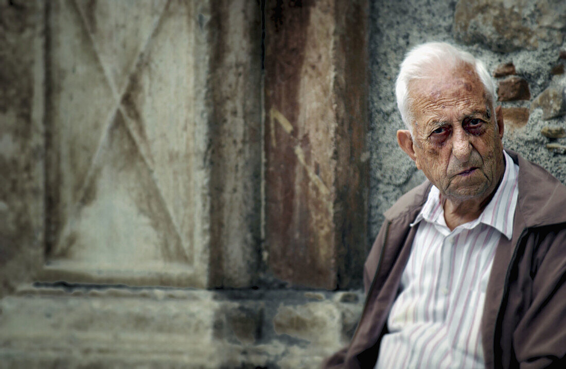 Old man outside of a church. Sicily, Italy