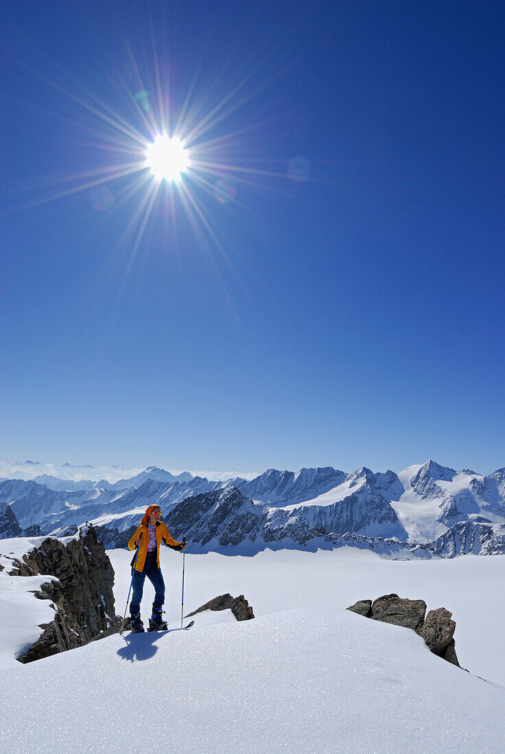 Female back-country skier ascending Lusener Spizte, Stubai Alps in background, Sellrain, Tyrol, Austria