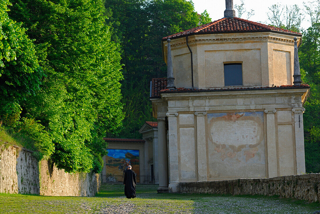 monk on pilgrimage path with chapel, Santa Maria del Monte, Sacromonte di Varese, World Heritage Site, Lombardy, Italy