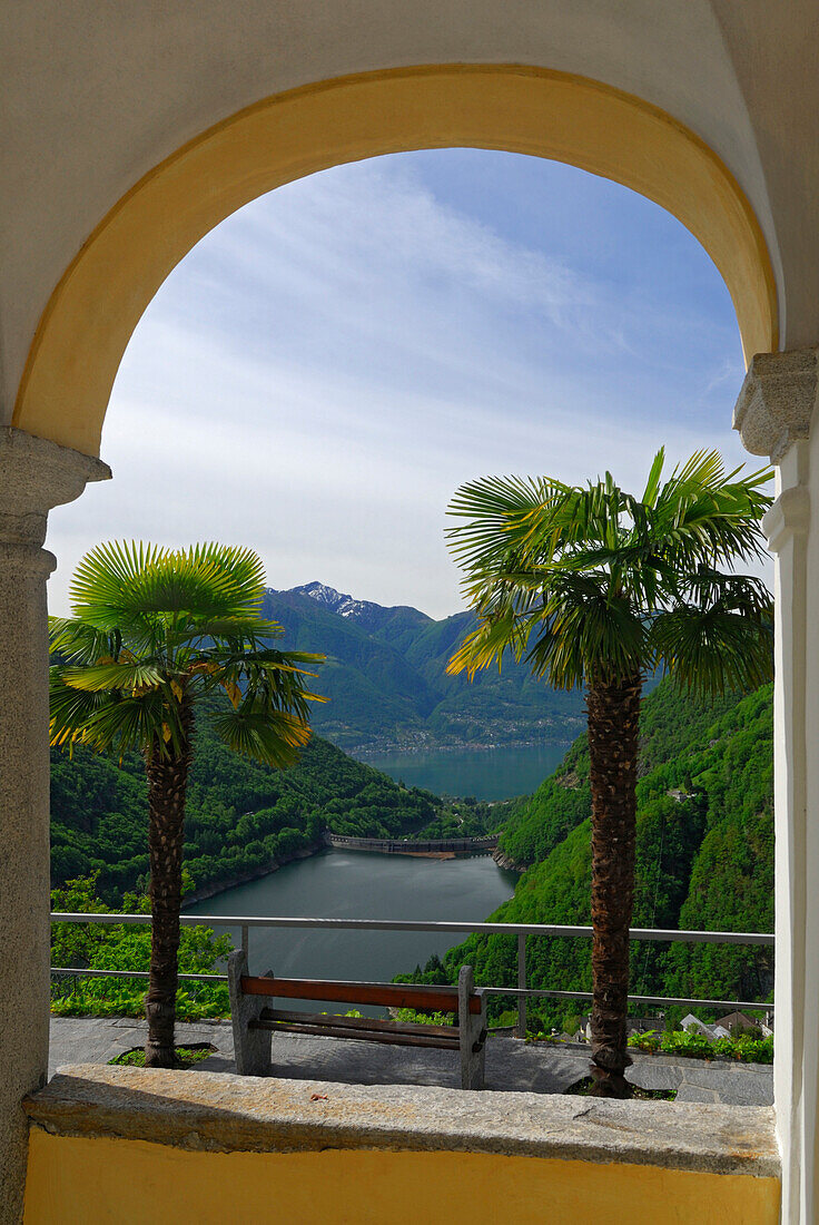 View through a archway to Lago di Vogorno with lake Lago Maggiore in background, Mergoscia, Ticino, Switzerland