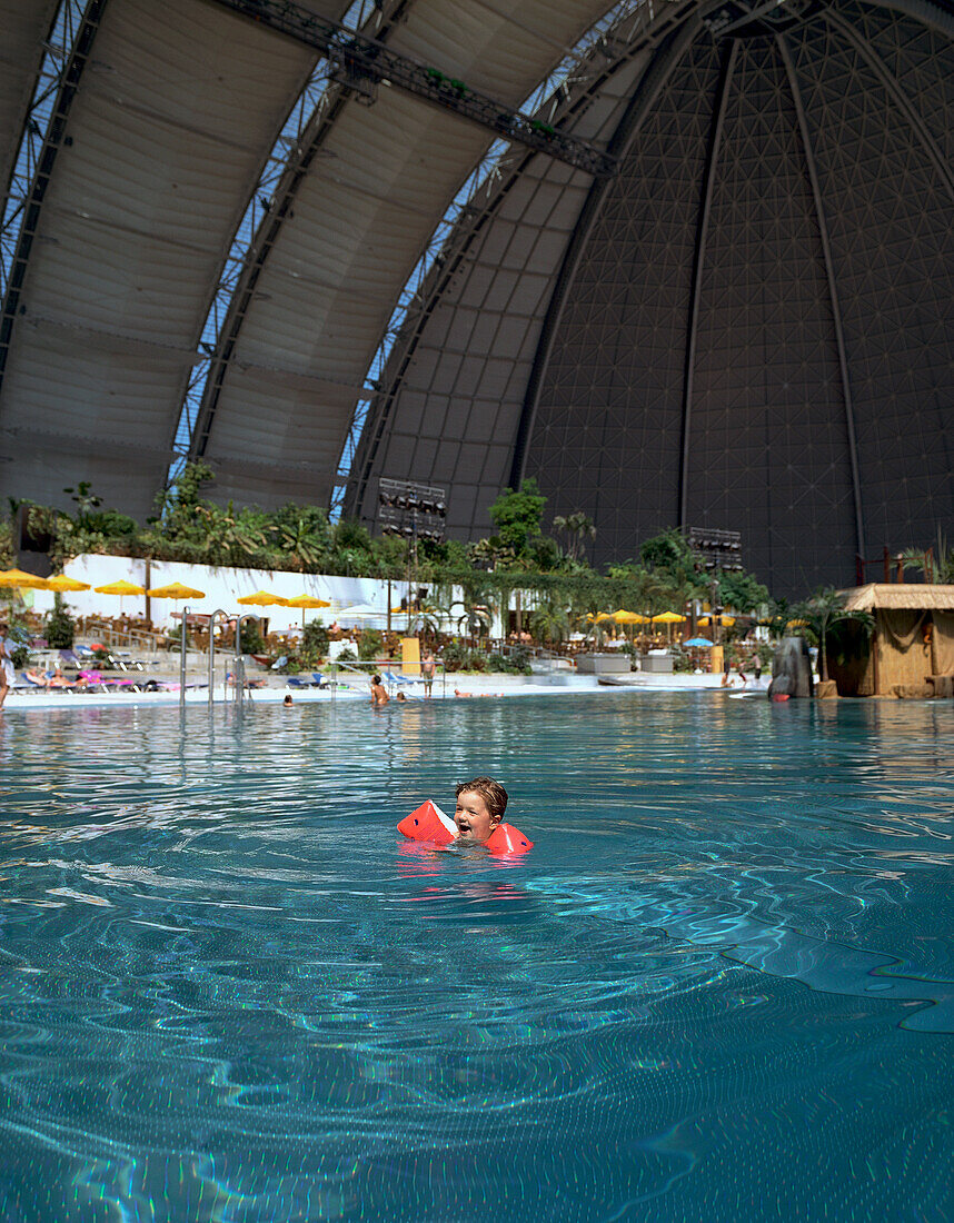 Girl swimming in pool, Tropical Island Resort, artficial beach world, in ex- Cargolifter hall (largest unsupported hall in the world: 360 x 210 x 107 m), in Krausnick, Lower Spreewald, Brandenburg, Germany