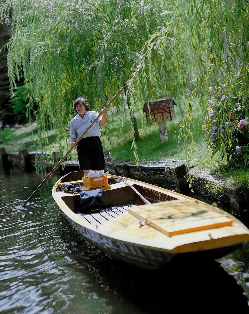 Jutta Prudenz, Germany`s only postwoman, who uses a punt to deliver mail; here in village of Lehde, Upper Spreewald, Spreewald, Brandenburg, Germany