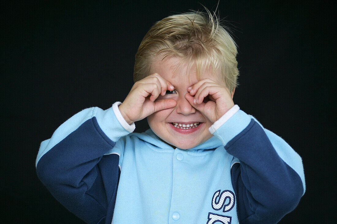 Young boy with fingers round eye, Child, Childhood, Family, Upbringing