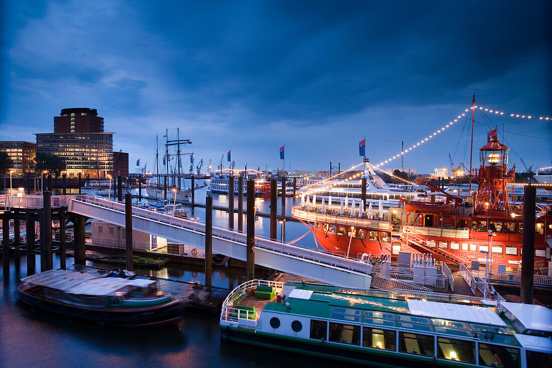 Illuminated fireboat in harbor at night, Hamburg, Germany