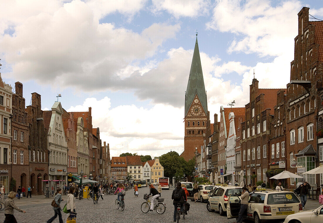 Gabled houses and St. Johannis Church Am Sande under clouded sky, Lueneburg, Lower Saxony, Germany, Europe