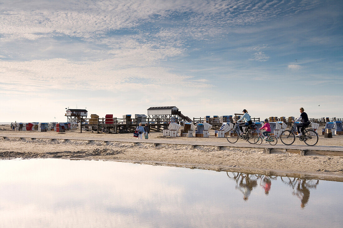 Cyclists at beach, St. Peter-Ording, Schleswig-Holstein, Germany
