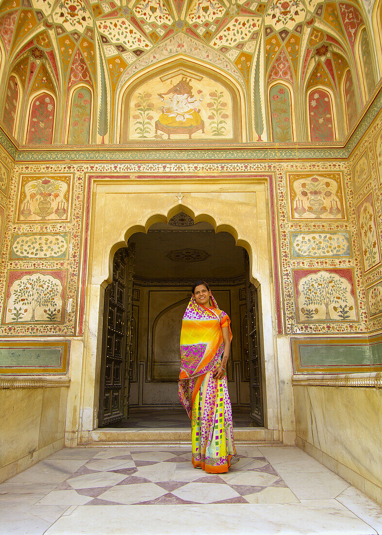 Woman in a sari at the Ganesh Pol (gate), Amber Palace, Amber (near Jaipur), Rajasthan, India