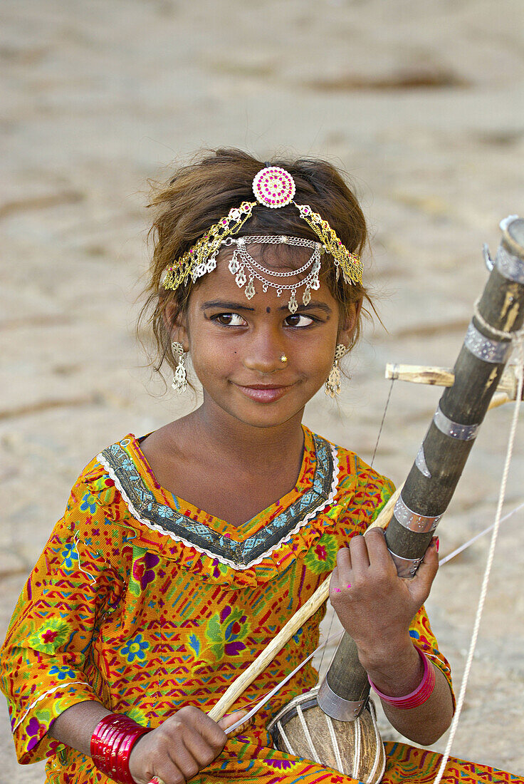 Girl playing musical instrument, Jaisalmer Fort, Jaisalmer, Rajasthan, India