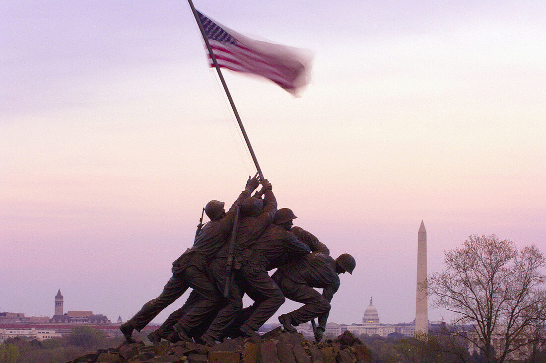 Statue of Marines holding American flag, Iwo Jima Memorial (United States Marine Corps War Memorial), with U. S. Capitol Building and Washington Monument in background, Arlington, Virginia