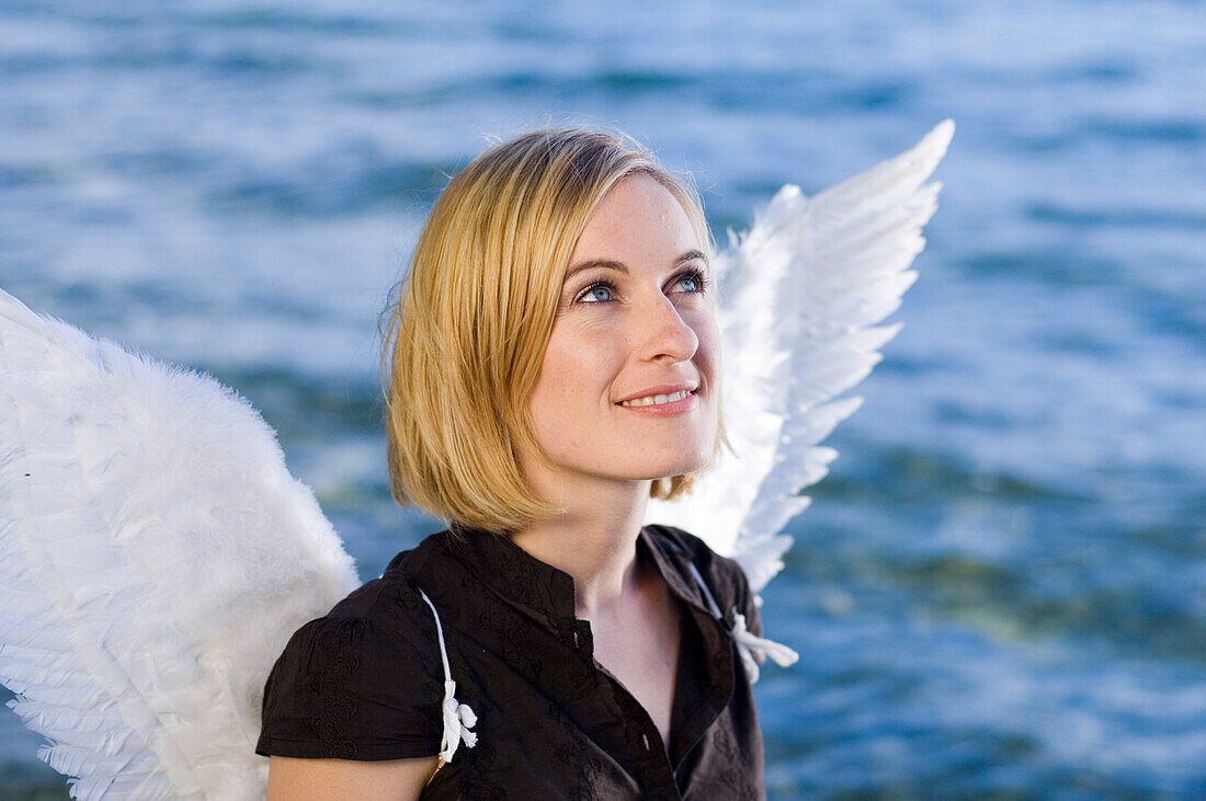 Angel, young woman with wings at Lake Starnberg, Bavaria, Germany