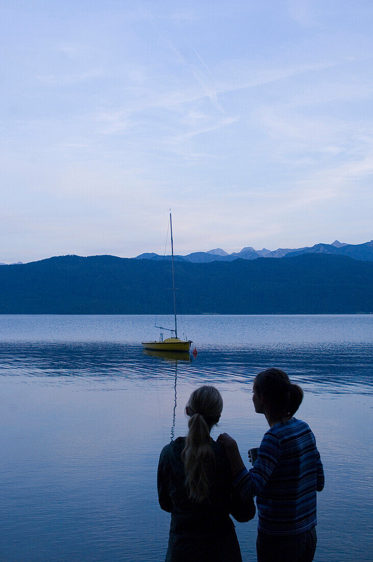 Two young women at lake Walchensee, Bavaria, Germany