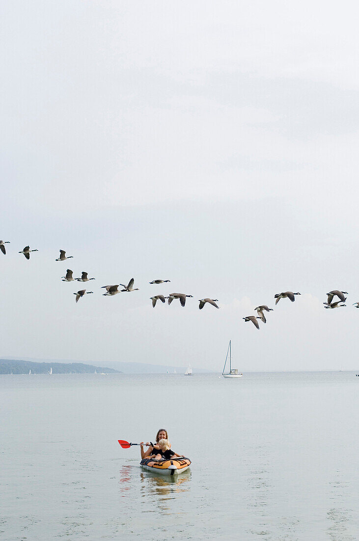 Mother and daughter in a dinghy, lake Ammersee, Bavaria, Germany