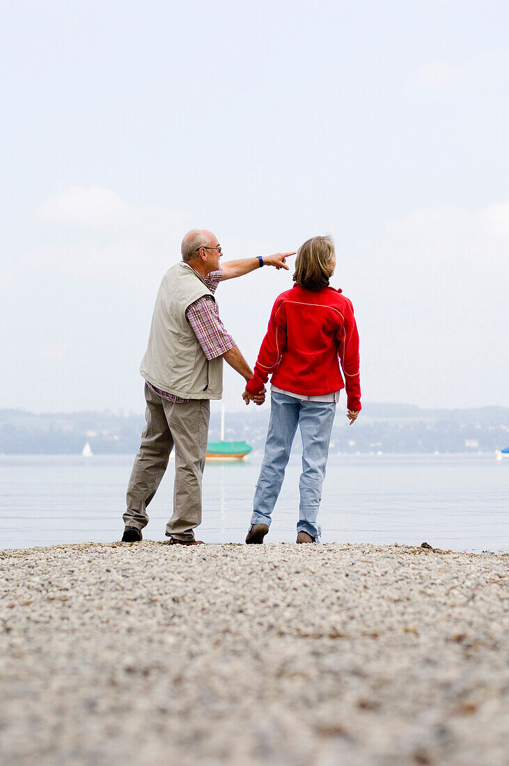 Senior couple standing at lake Ammersee, Bavaria, Germany