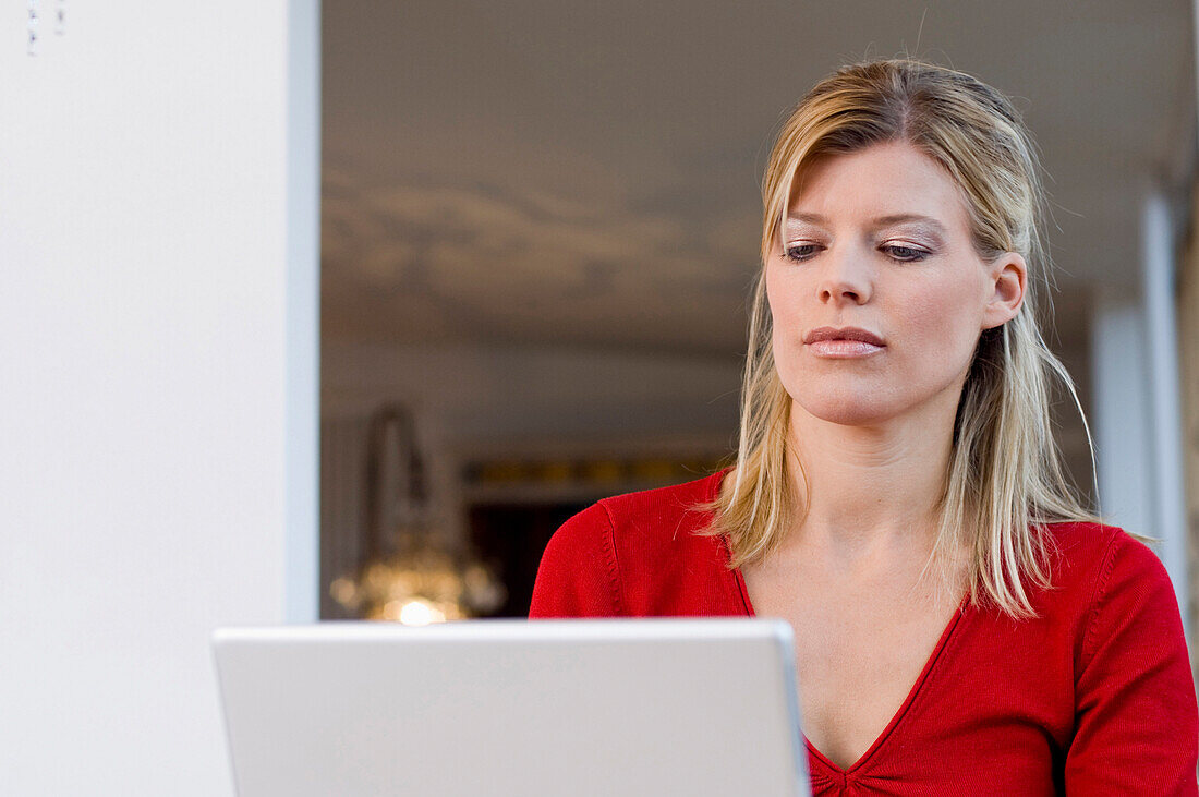 Frau mittleren Alters arbeitet an einem Laptop