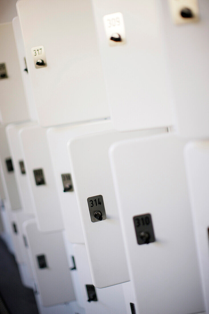 Close up of white lockers, some open