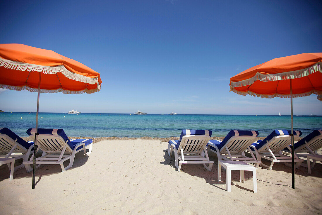 Sunshades and sun loungers on Tahiti beach, St. Tropez, Cote d'Azur, Provence, France