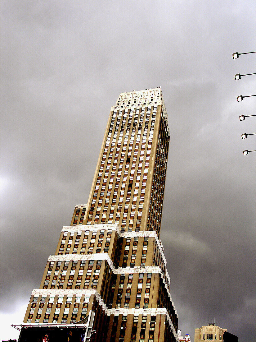Kane Office Tower on 7th Avenue in New York City. The building is tilted against a cloudy sky. Picture has a painter like quality about it. USA.