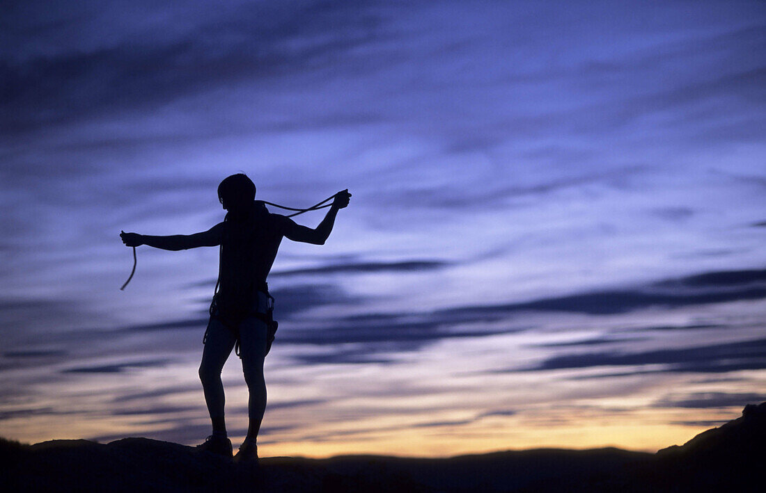 Male climber at sunset . Peñarroya de Tastavins. Teruel. Aragón. Spain