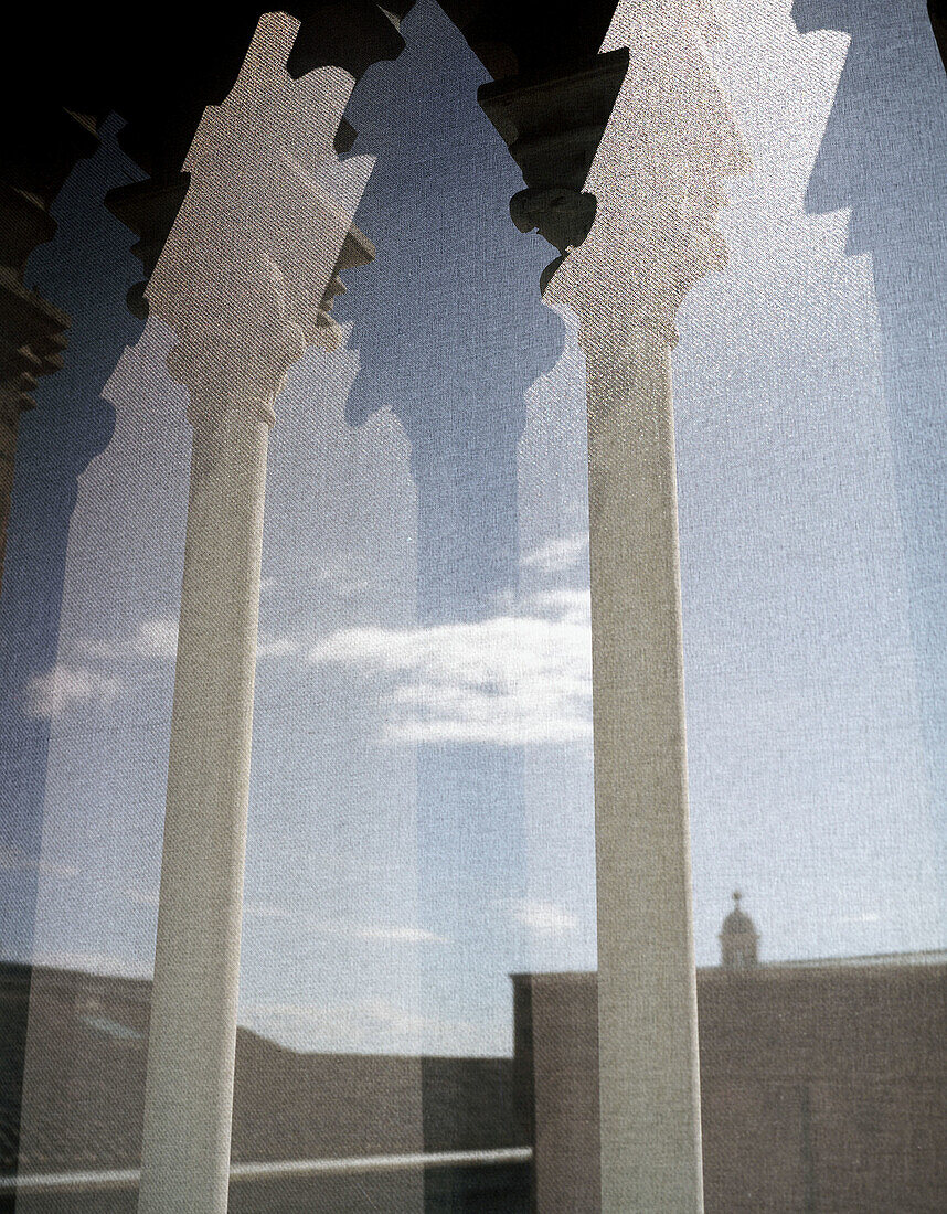 Columns and sky of Siena, Italy, through building shades