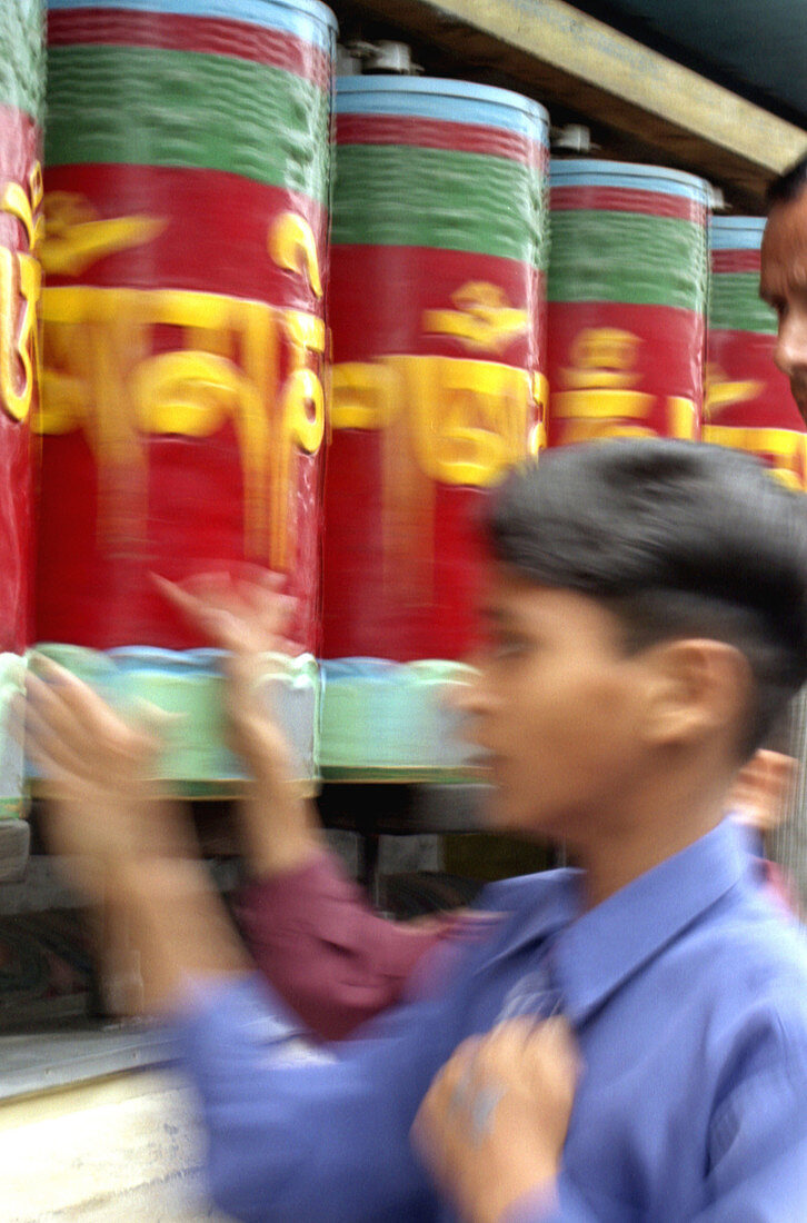 Boy spinning prayer wheels in McLeod Gang, North India.