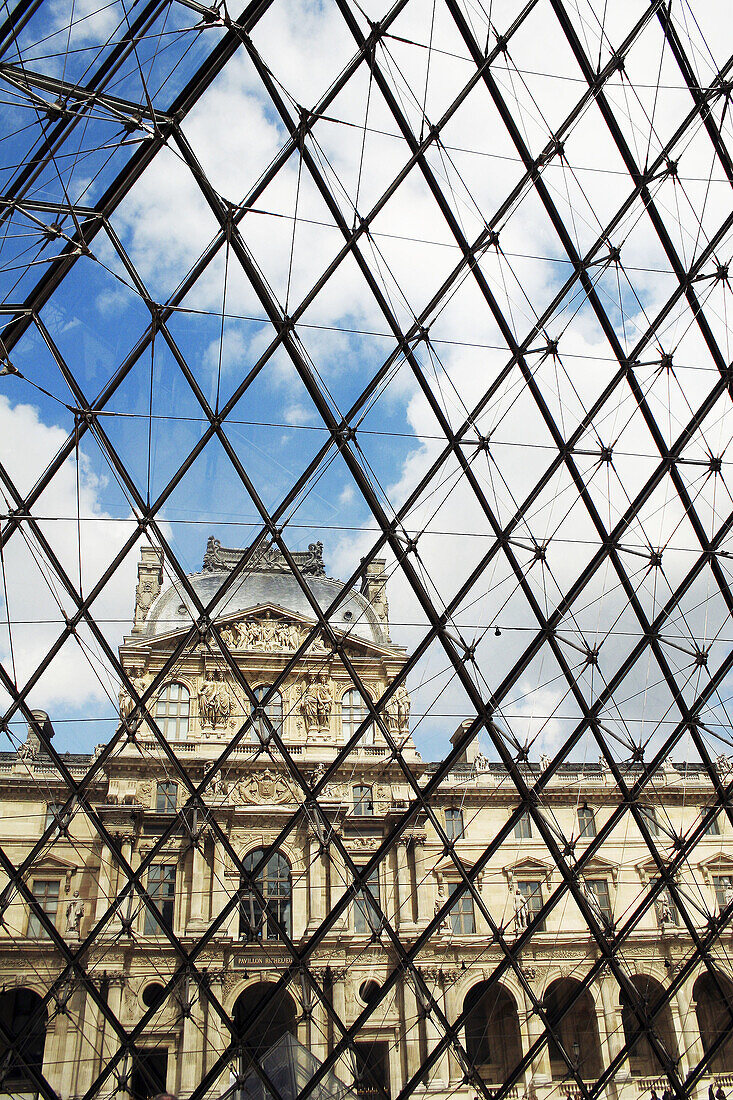 Louvre Museum façade as seen from the inside of the pyramid. Paris. France.