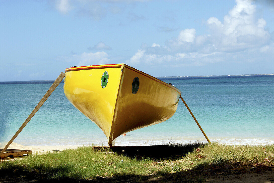 Beached canoe, sea in background
