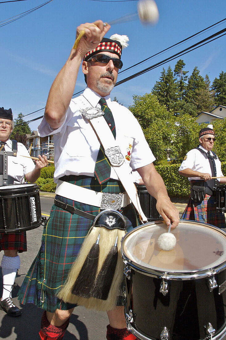Comox Nautical Days Parade. Scottish Bagpipe band drummer. BC, Canada