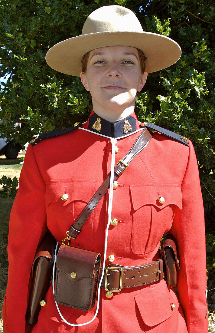 Comox Nautical Days Parade. A young female Royal Canadian Mounted Police officer in uniform. BC, Canada