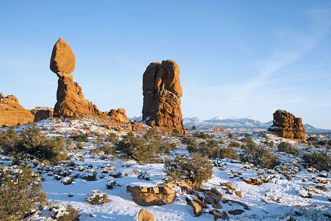 Balanced Rock and the La Sal mountains under a blanket of winter snow, Arches National Park, Utah, USA.