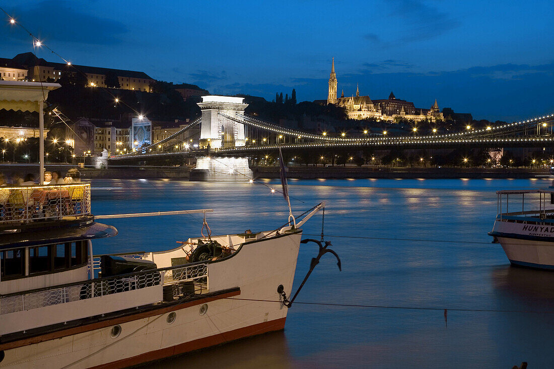 Chain bridge, Matthias Church, restaurant-boat and Danube river. Budapest. Hungary. 2006.