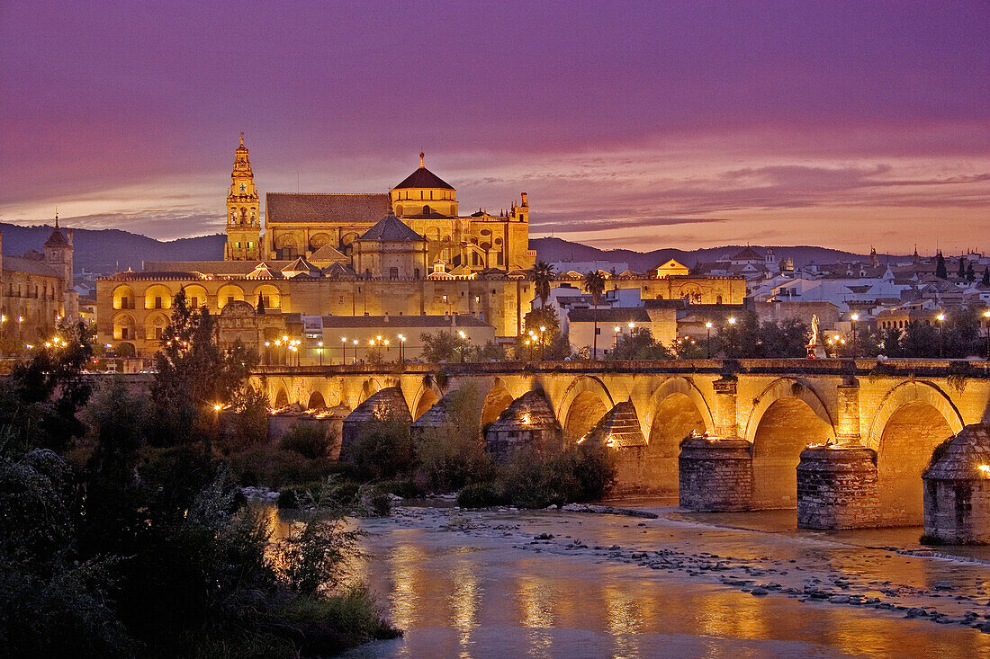 Guadalquivir river, Roman bridge and mosque-cathedral in the evening. Córdoba. Andalucia. Spain.
