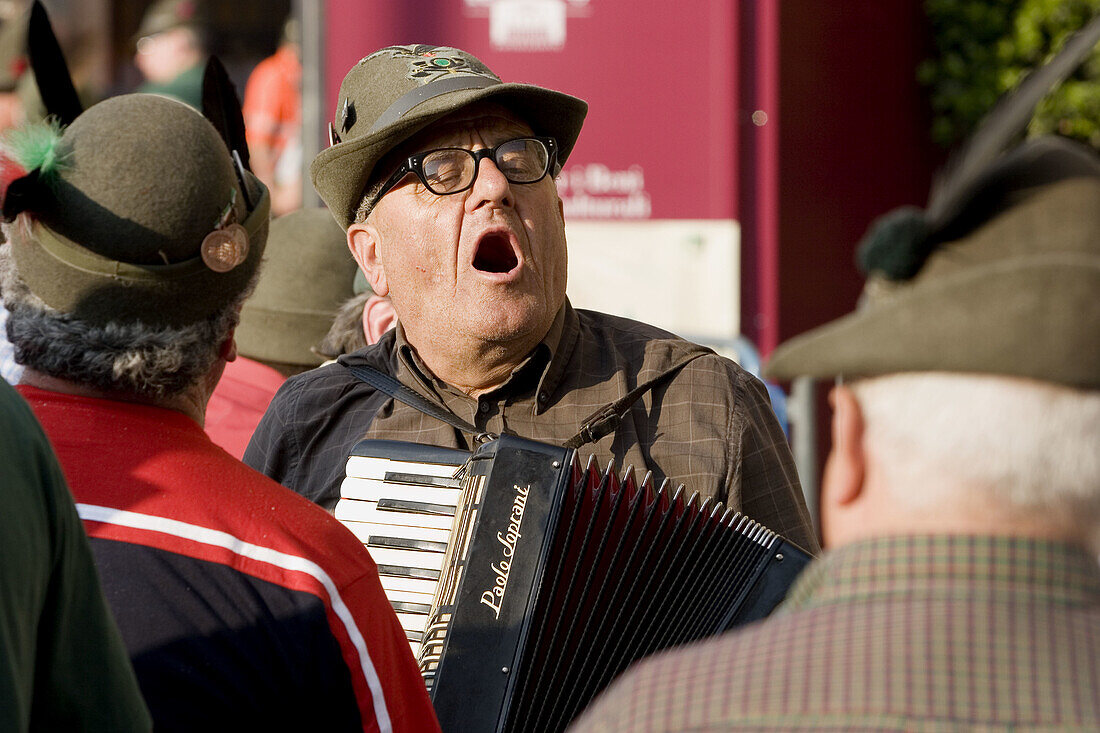 Adunata Nazionale (yearly reunion of former soldiers) of Alpini (a highly decorated elite infantry corps of the Italian Army): old Alpino singing and playing accordion during the military parade