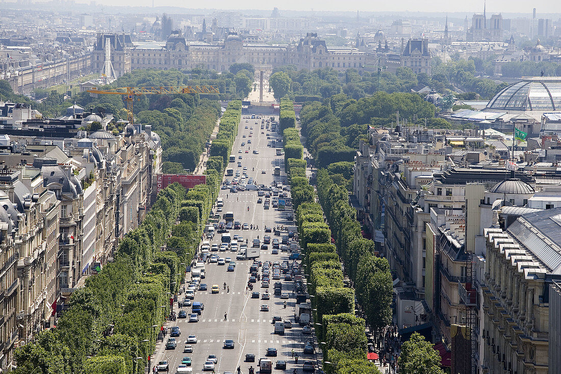 Champs Elysees Avenue, Concorde Obelisk and Louvre Museum in background. Paris. France.