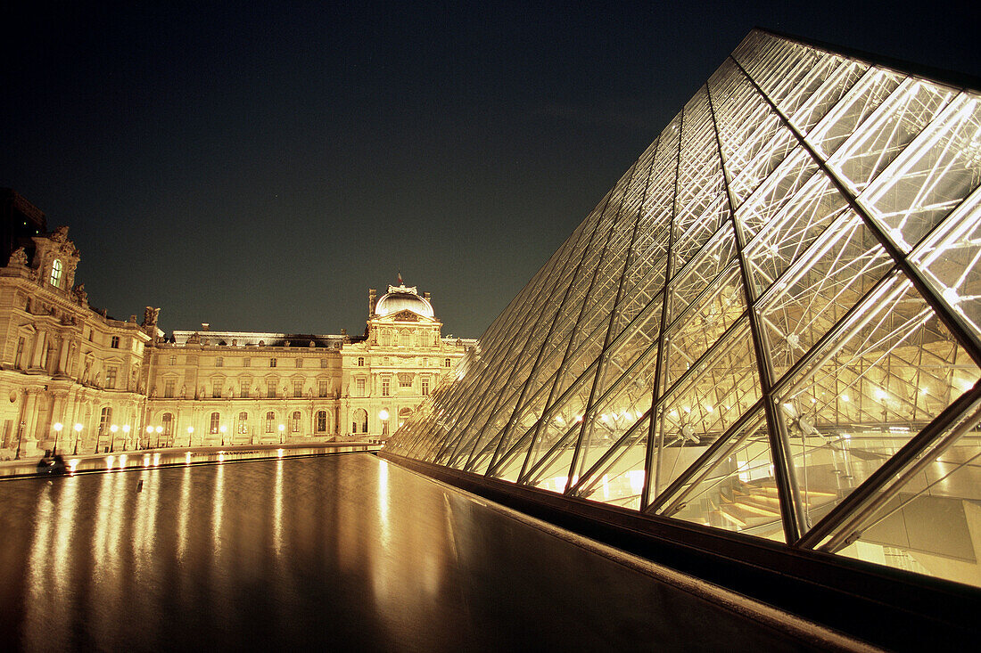 Pyramid of the Grand Louvre art museum and Cour Napoleon by night, Paris. France