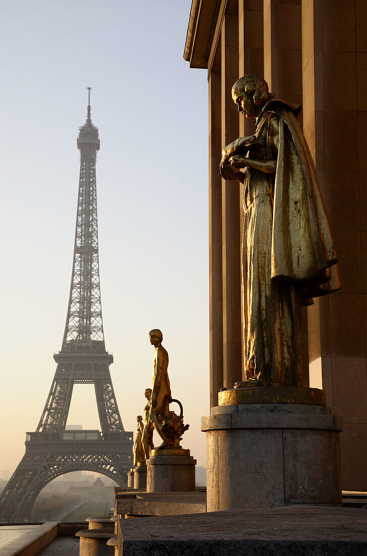 Golden statues of the Palais of Chaillot and the Eiffel Tower. Paris. France