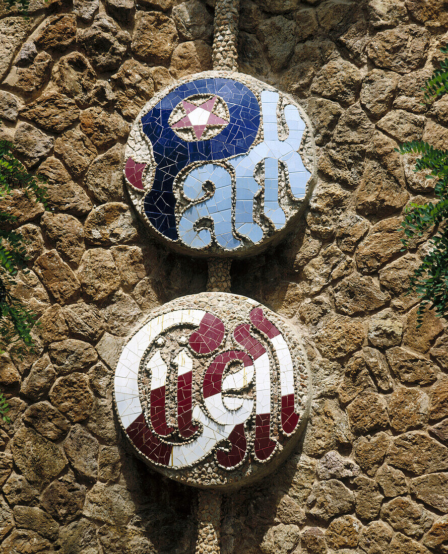 Logo mosaic in the Parc Güell (Gaudí, 1900-1914). Barcelona. Spain