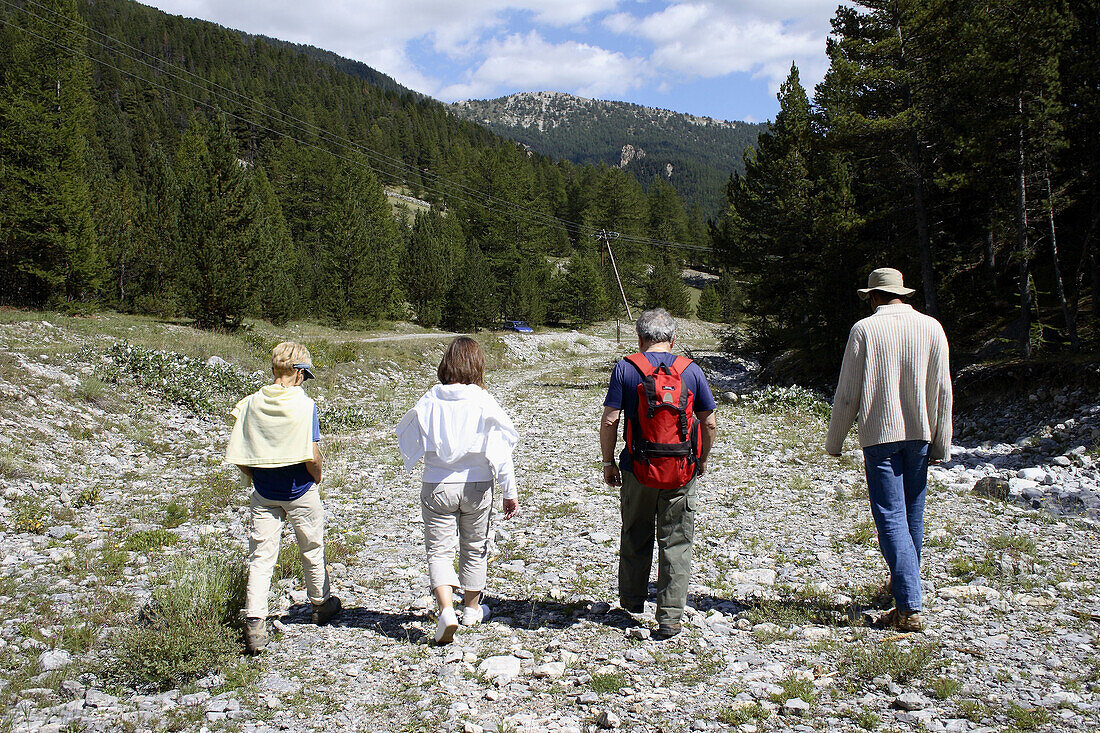 Four people taking a walk. Brunissard. Arvieux. Queyras. Hautes-Alpes. France.