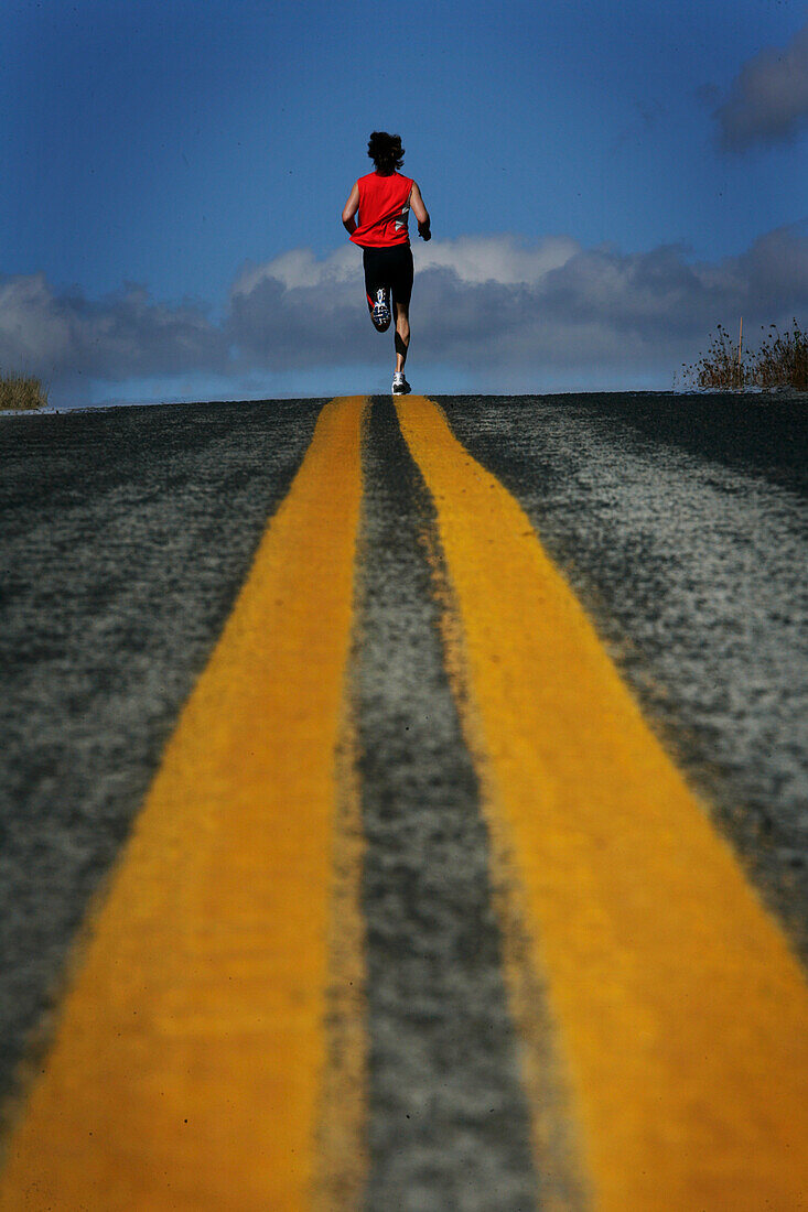 Runner, man running on a country road near Mount Hood, from Mount Hood to seaside, Oregon, USA, model release