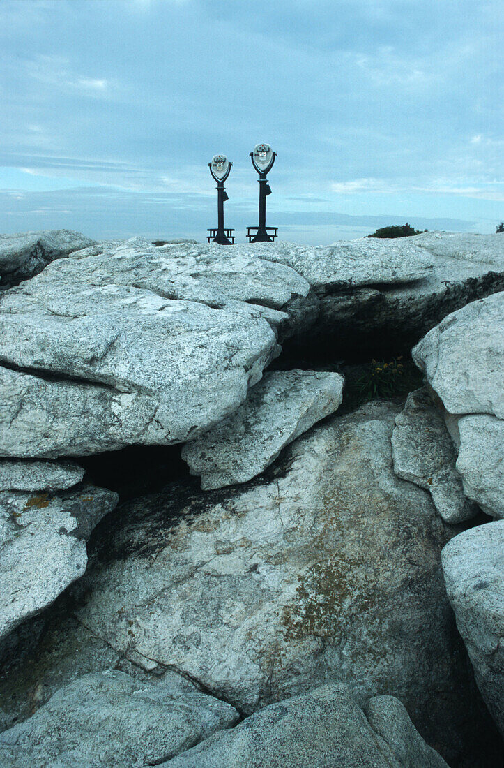 Binoculars overlooking a rocky shore, Maine, USA