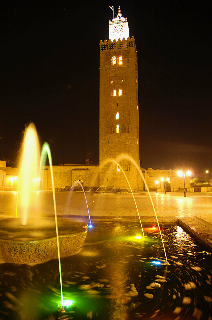 Koutoubia mosque with fountain and colour lights. Marrakech. Morocco.