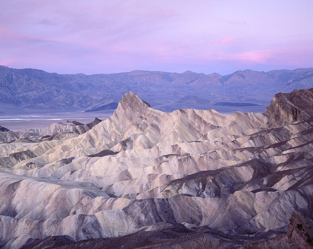Pre-sunrise glow on Manley Beacon as seen from  Zabriskie Point. Death Valley National Park. California. USA.