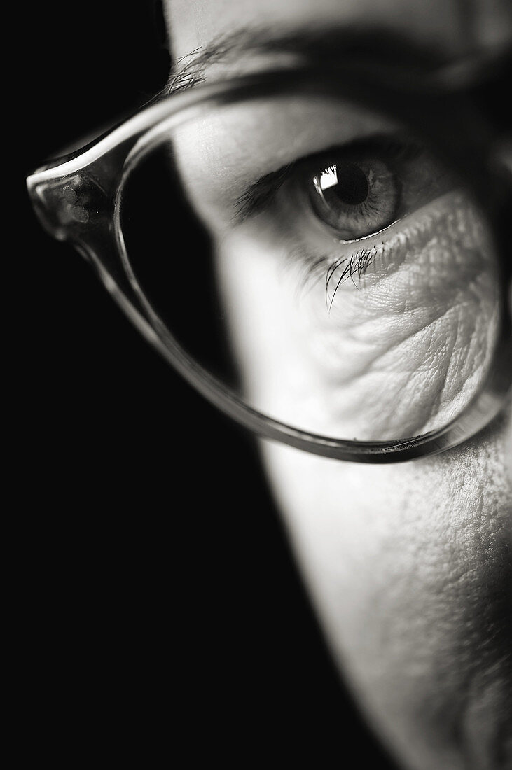 Face with wrinkles. Detail of eye with glasses.