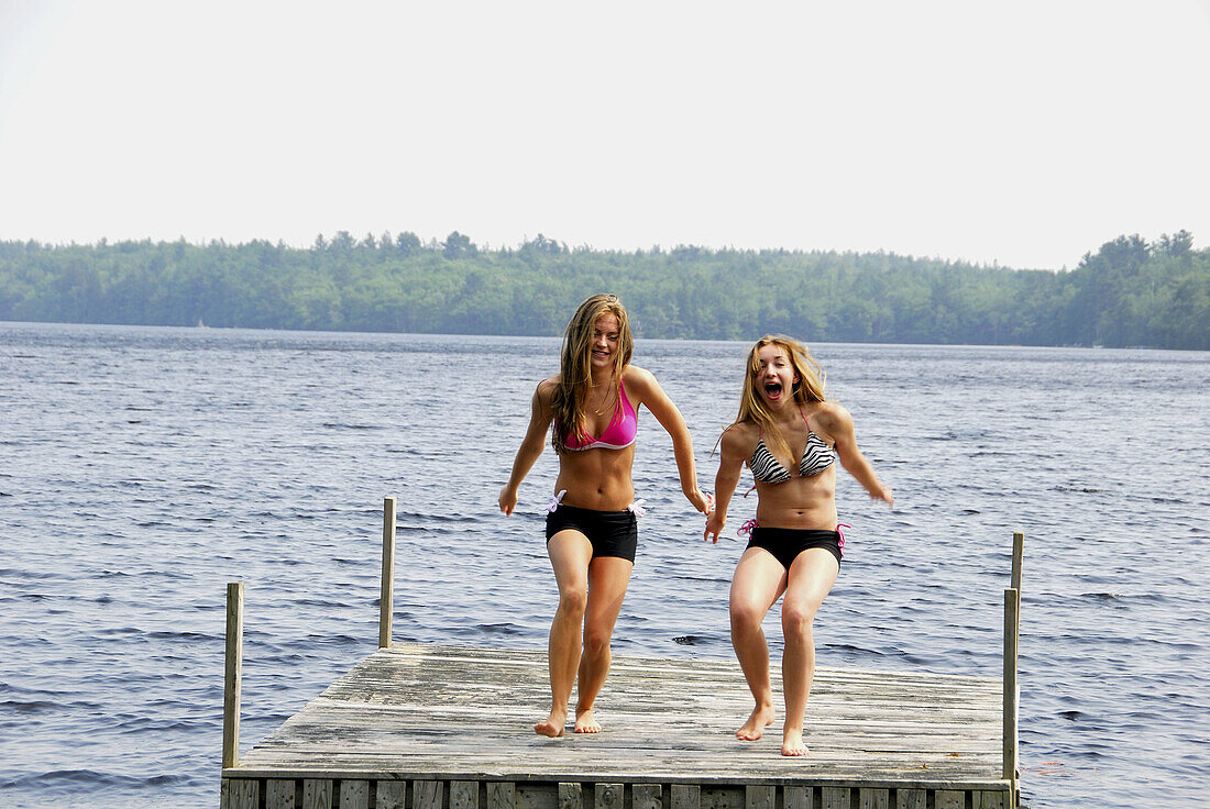 girl 13 girl 18 yrs about to jump into lake from dock