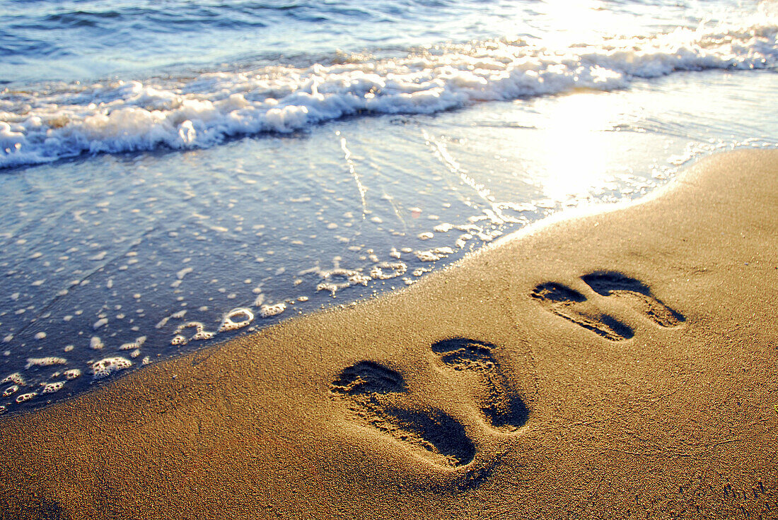 couples footprints on beach