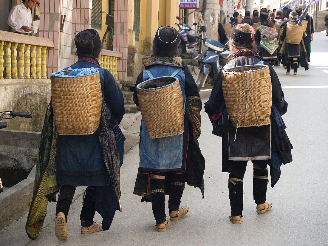 Three black Hmong women walk home from market. Sapa, Vietnam (april 2006)